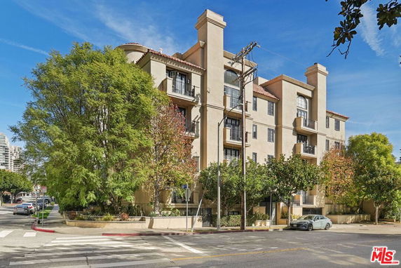 Front view of a multi-story apartment building with balconies.