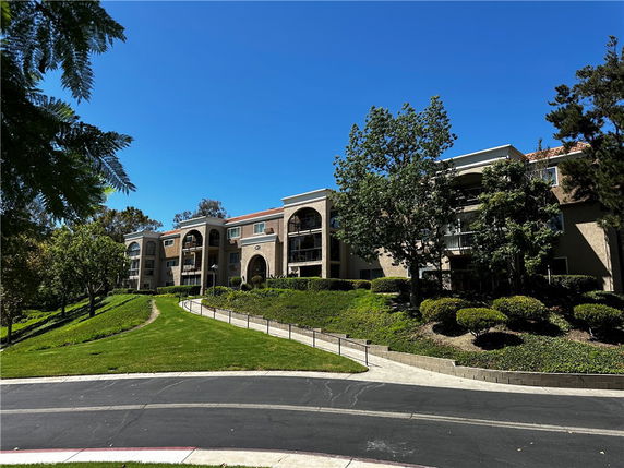 Front view of a multi-story residential building with balconies.