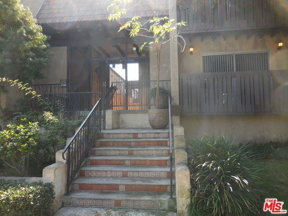 Front view of a building with tiled steps leading to an entrance.