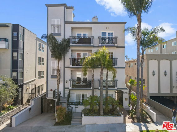 Front view of a multi-story apartment building with a modern design.