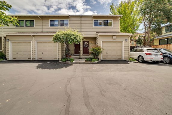 Front view of a two-story residential building with attached garages.