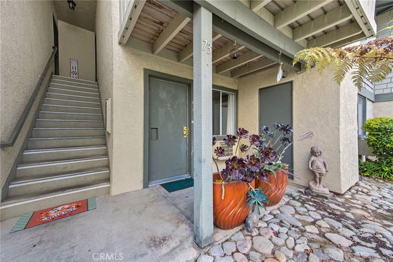 Front view of a two-story building with stairs leading to the upper level.