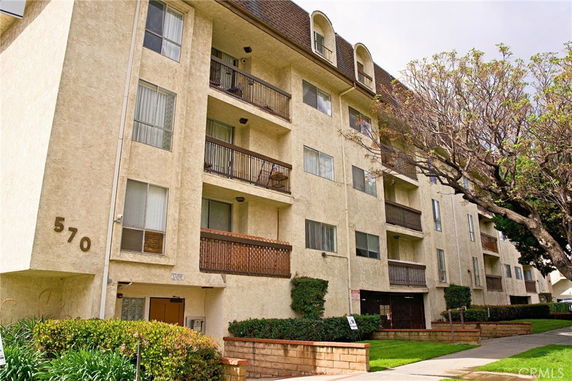 Front view of a multi-story apartment building with balconies.
