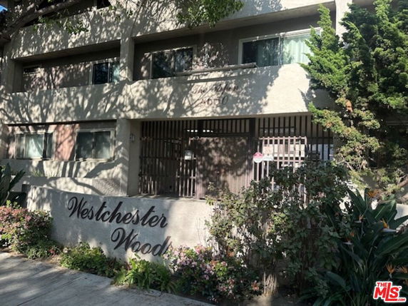 Front view of a multi-story building with balconies.