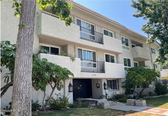 Front view of a multi-story residential building with balconies.