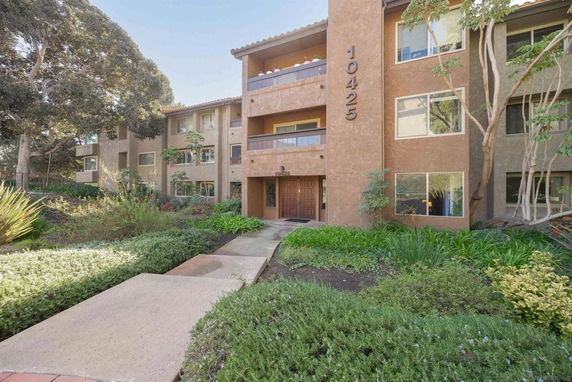 Front view of a multi-story apartment building with balconies and building number 10425.
