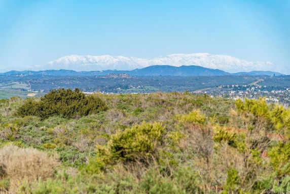 A wide-angle view of surrounding natural landscape with mountains in the background.
