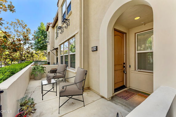 Front view of a two-story house with an archway entrance.
