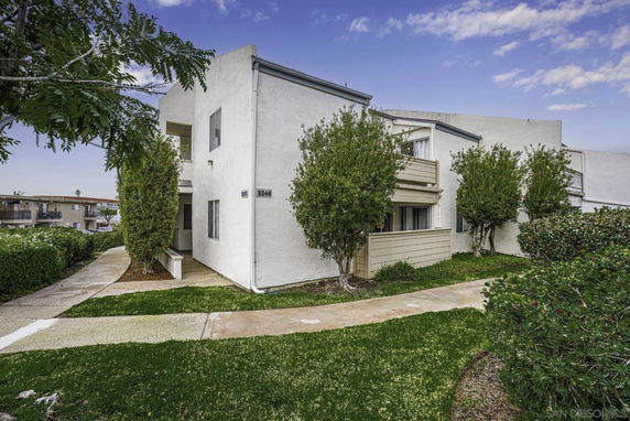 Front view of a two-story white building with a small balcony.