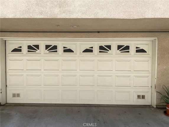 Front view of a garage door with decorative windows.