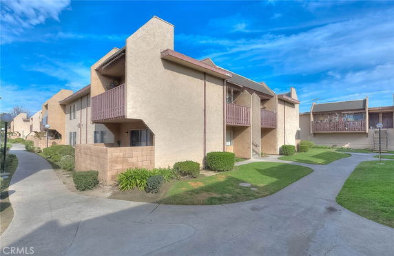 Front view of a two-story apartment building with balconies.