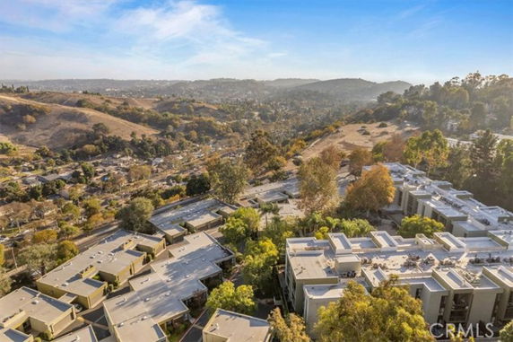 Panoramic view of residential buildings with surrounding hills.