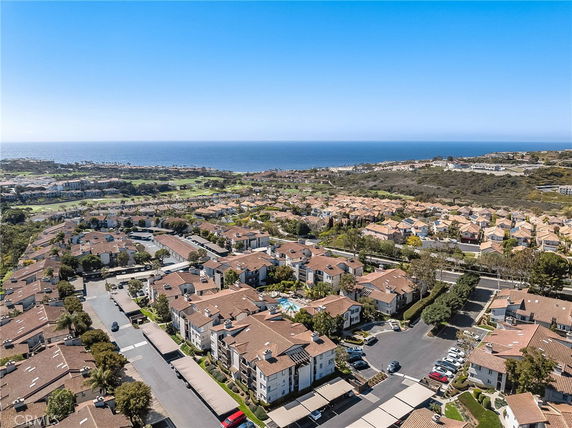 Panoramic view of a residential area with ocean in the background.
