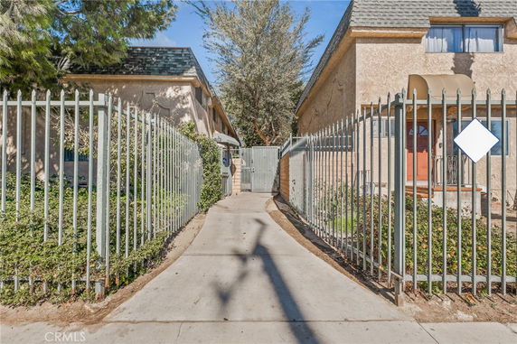 Front view of two adjacent buildings with gated entrance.