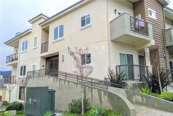 Front view of a multi-story building with balconies.