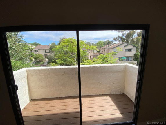 View from an indoor balcony showing surrounding residential area.