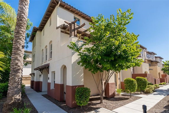 Front view of a two-story house with a Mediterranean architectural style.