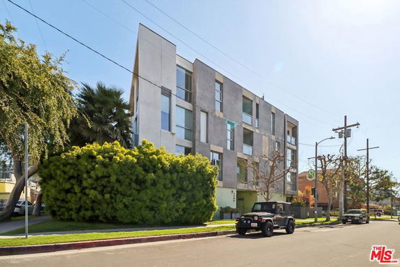 Front view of a multi-story apartment building with modern design.