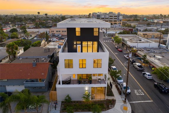 Front view of a modern multi-story building with balconies.