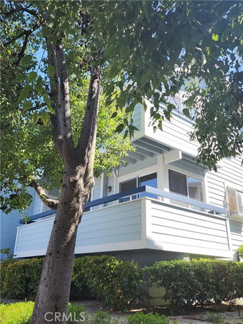 Front view of a two-story house with a porch and railing.