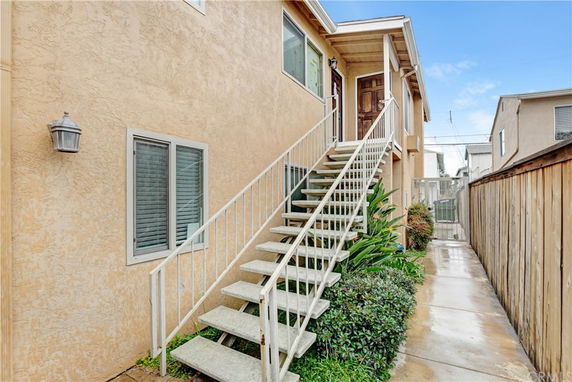 Front view of a house with external staircase leading to the entrance.