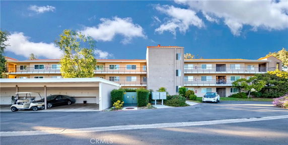 Front view of a multi-story building with balconies.