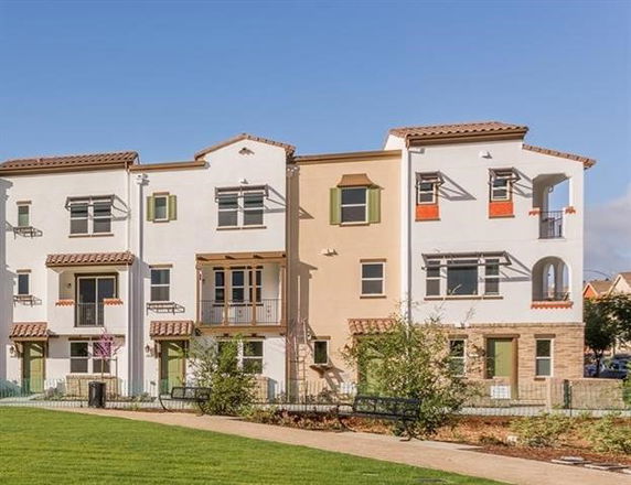Front view of a multi-story residential building with balconies.