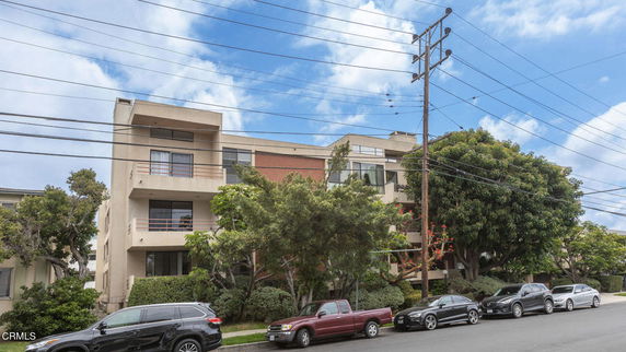 Front view of a multi-story residential building with balconies.