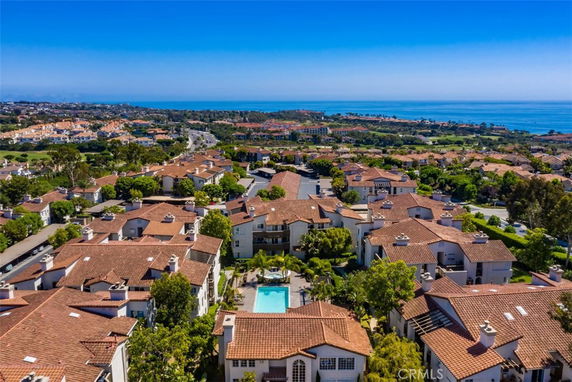 Panoramic view of a residential area with tile-roofed houses near the coast.