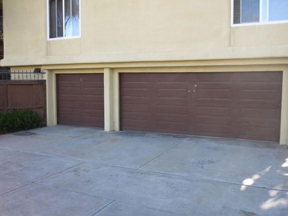 Exterior view of a house with a double garage door.