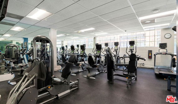 Well-equipped gym area with various exercise machines and equipment.
