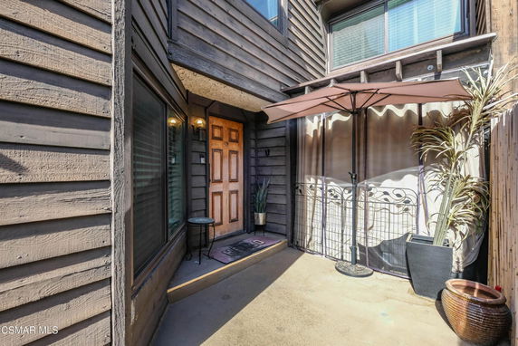 Front view of a house with wood siding and a door entrance.
