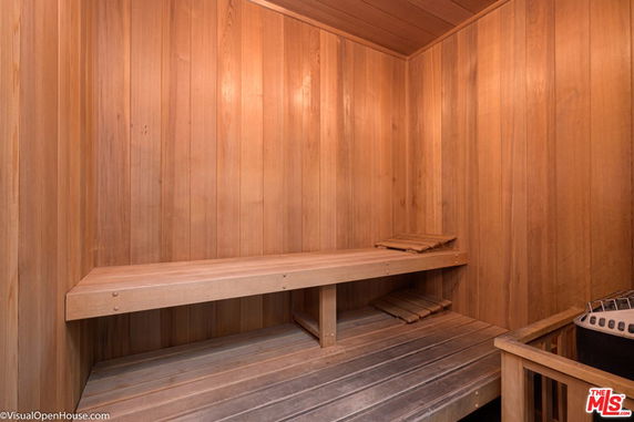 Interior view of a wooden sauna with benches.