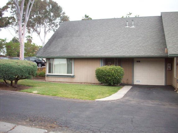 Front view of a single-story house with a sloped roof and attached garage.