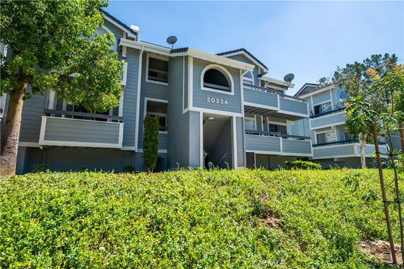 Front view of a multi-story residential building with balconies.