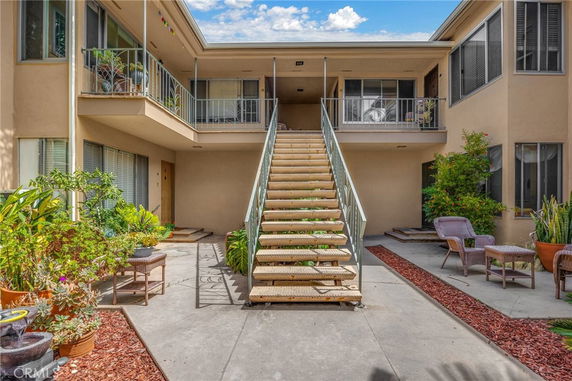 Front view of a two-story building with a central staircase leading to the upper level.