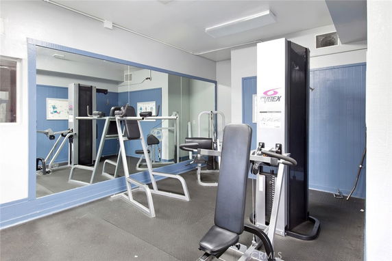 Interior view of a home gym with various exercise equipment.