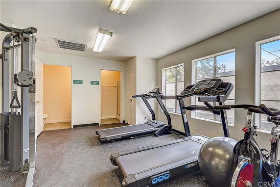 Indoor gym area with exercise equipment including treadmills and a multi-station machine.