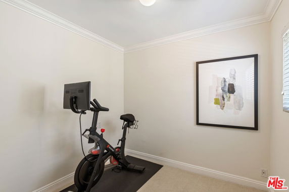 Room with exercise bike and wall art