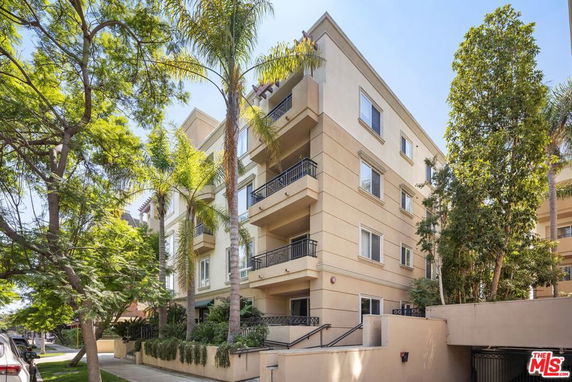 Front view of a multi-story residential building with balconies.