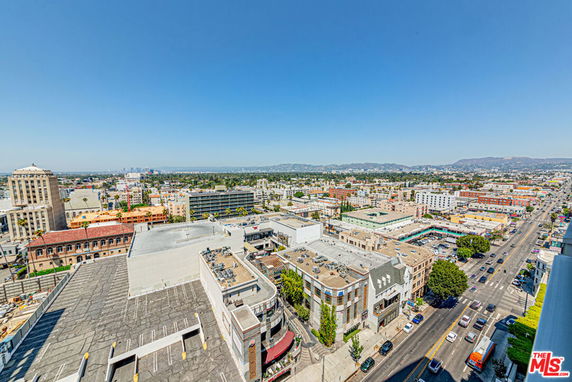 Wide view of cityscape with buildings and roads extending into the distance.
