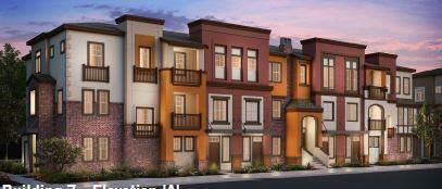Front view of a multi-story building with a combination of brick and stucco facade.