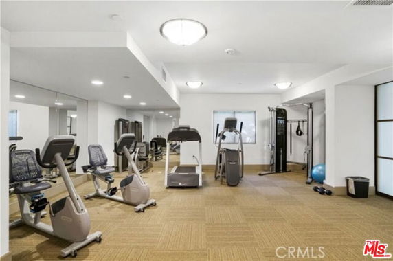 Indoor gym area with exercise machines and equipment.