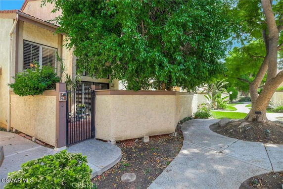 Front view of a house entrance with a gated courtyard.