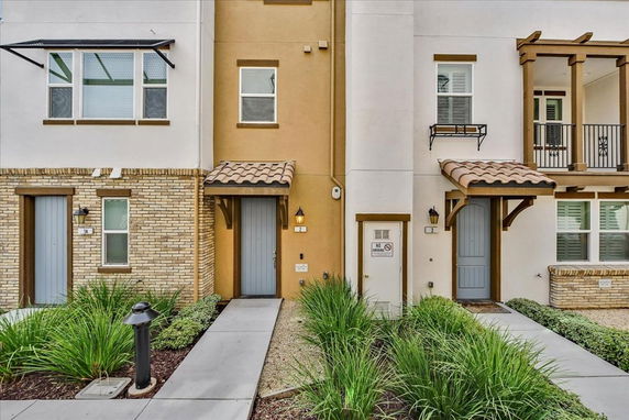 Front view of a multi-story residential building with separate entrances.