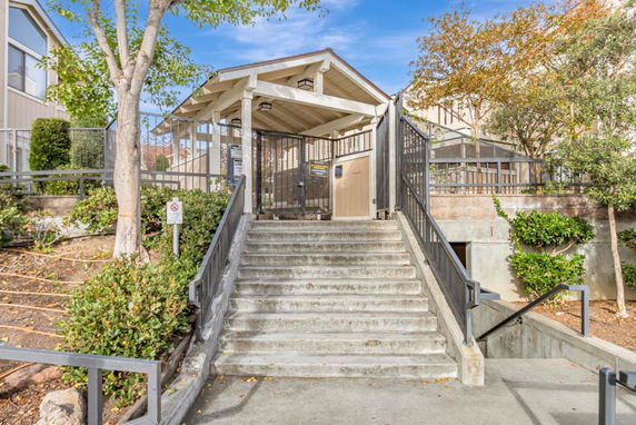 Front view of a gated building entrance with stairs.