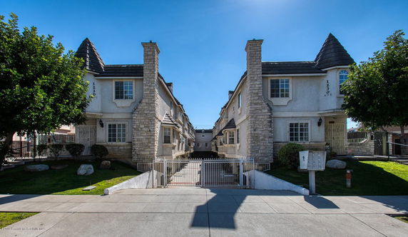 Front view of a residential building with stone and stucco facade.