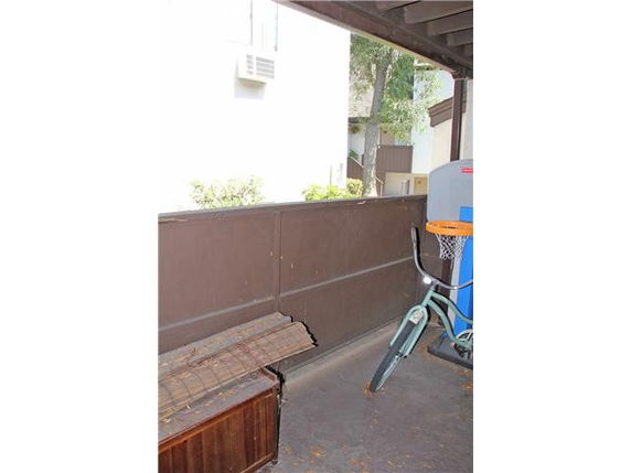 Outdoor area with a bicycle and a small basketball hoop.