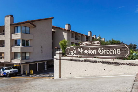 Front view of a multi-story residential building with balconies.