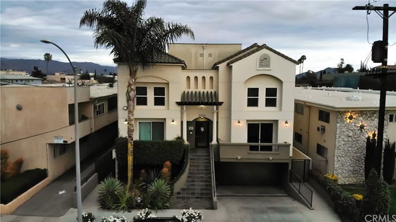 Front view of a multi-story house with a central entrance and garage.